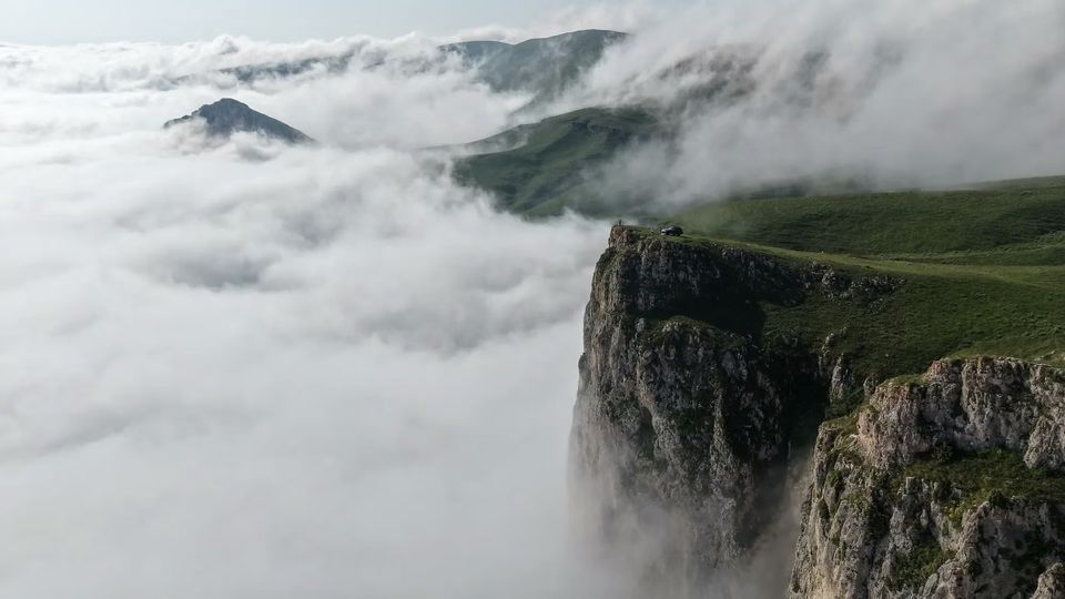 Cliff edge of Mount Dimats above a sea of cloud